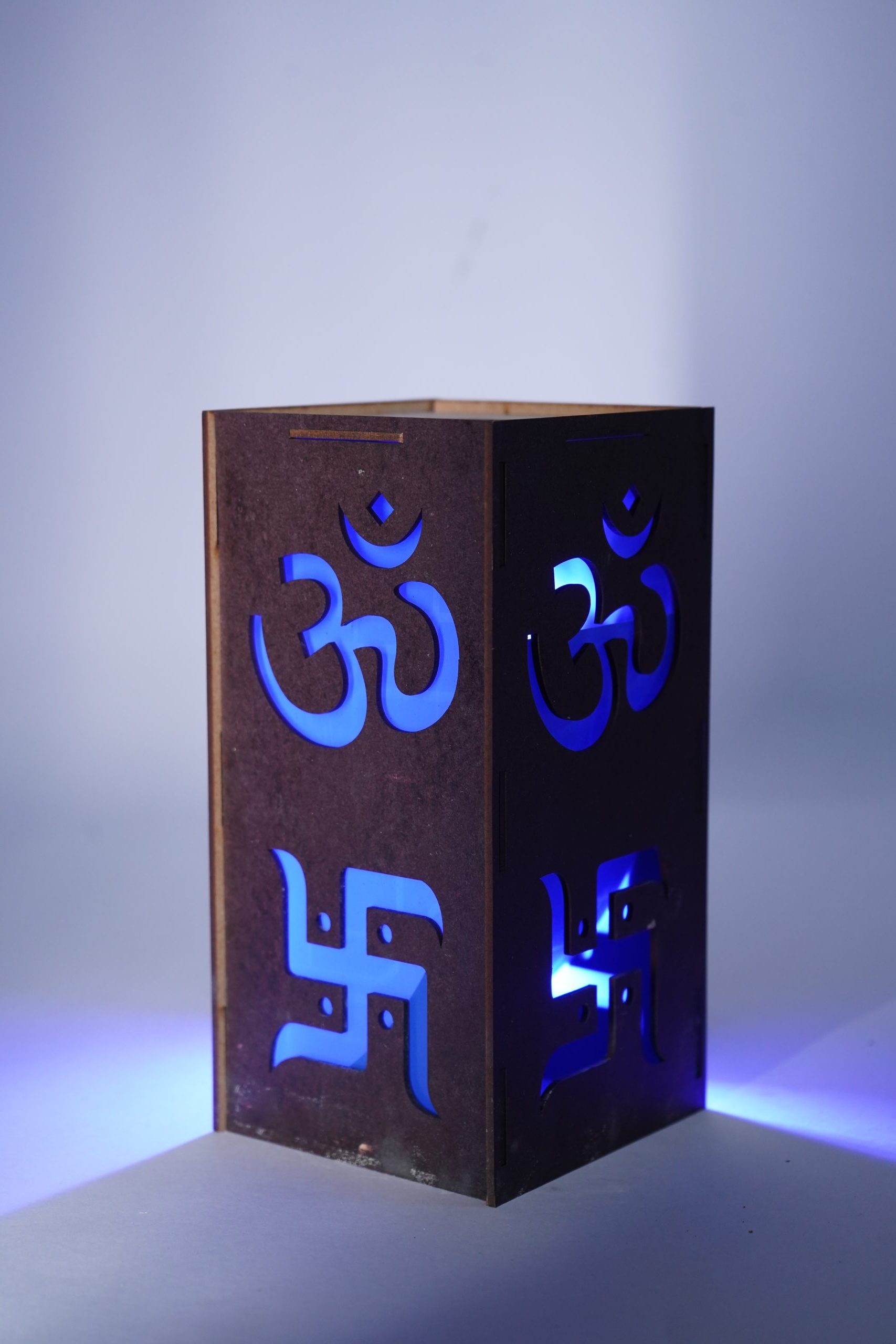 SML05002-scaled-e1757180016186.jpg LED Sanskrit Symbol Wall Light, Blue Illuminated Sign, Wood Metal Frame - Image 1